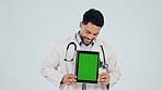 Green screen, man and portrait of doctor with tablet in studio for clinic sign up, FAQ and telehealth. Technology, happy and healthcare worker on app for medical information by white background.