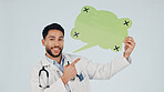 Speech bubble, pointing and doctor in studio for portrait, announcement and health advice. Happy, healthcare and man with poster for news, information or tips for medical service on white background