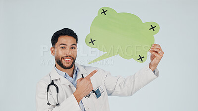 Buy stock photo Speech bubble, pointing and doctor in studio for portrait, announcement and health mockup. Happy, healthcare and man with poster for social media news, tips and medical service on white background