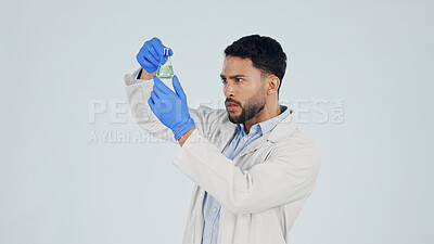 Buy stock photo Scientist, man and studio with chemical beaker for liquid experiment on a white background. Thinking, male person or checking compound with glass for science discovery, test or medical research space