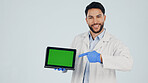 Green screen, pointing and portrait of doctor with tablet in studio for clinic sign up or FAQ in studio. Technology, space and healthcare worker on app for medical information by white background.