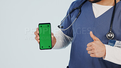 Buy stock photo Nurse, phone and thumbs up with green screen in studio for marketing app on a white background. Person, healthcare worker or hands showing mockup space with like emoji for advertising or good review