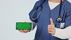Nurse, phone and thumbs up with green screen in studio for advertising or Telehealth app. Person, hands or healthcare worker with like emoji or technology mockup for marketing on a white background