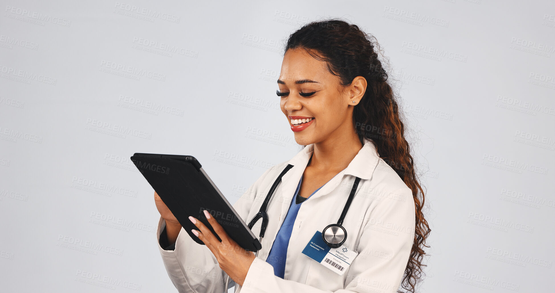 Buy stock photo Tablet, woman and doctor in studio with research for medical diagnosis, telehealth or treatment. Digital technology, reading and female healthcare worker with online consultation by white background.