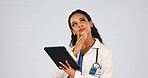 Tablet, thinking and doctor in studio with research for medical diagnosis, telehealth or treatment. Technology, woman and healthcare worker with planning for online consultation on white background.