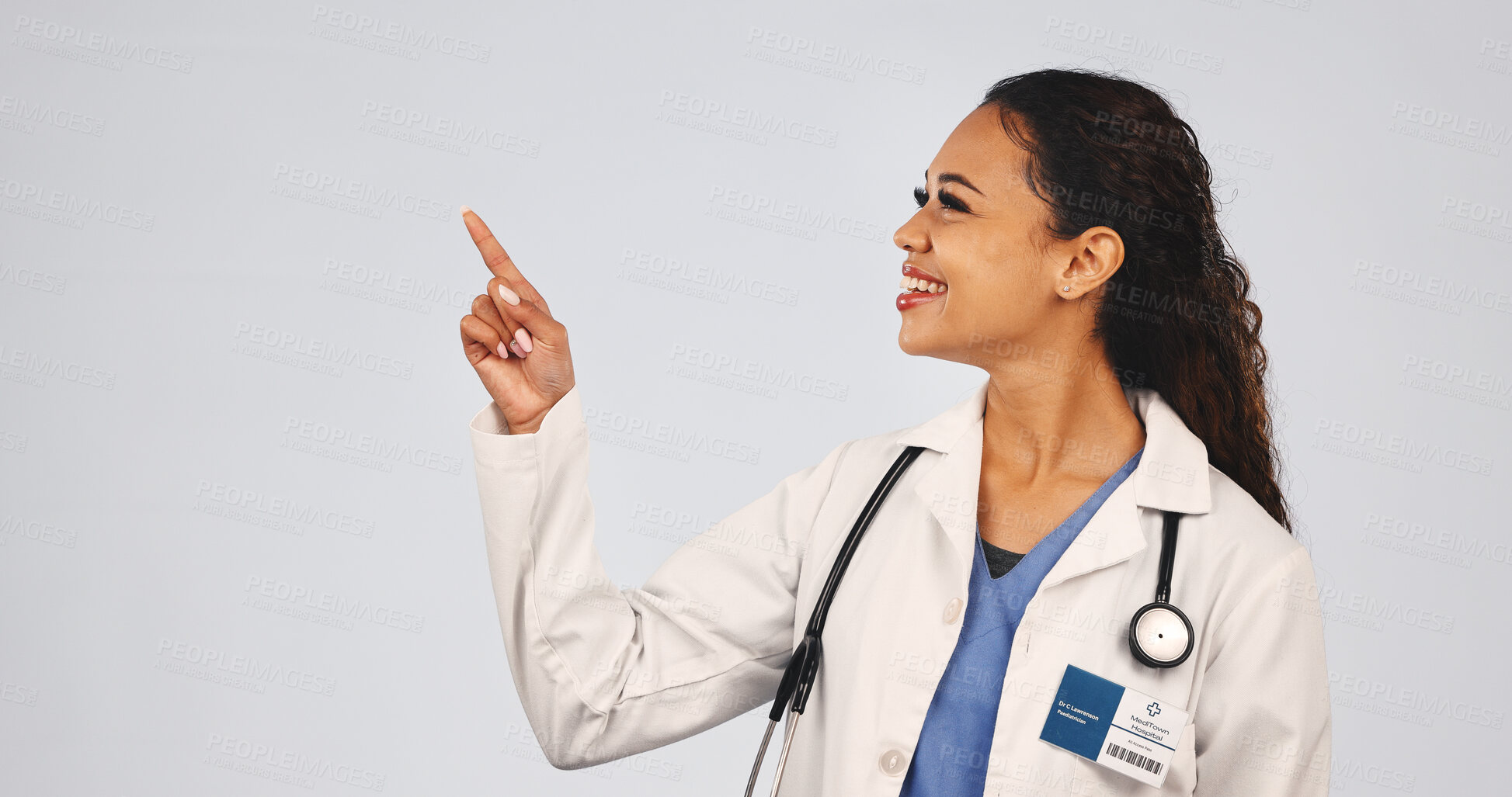 Buy stock photo Medical, pointing and doctor with smile, treatment list and reminder in healthcare information. Mockup space, surgeon or woman with instruction, recovery plan and wellness steps on studio background.