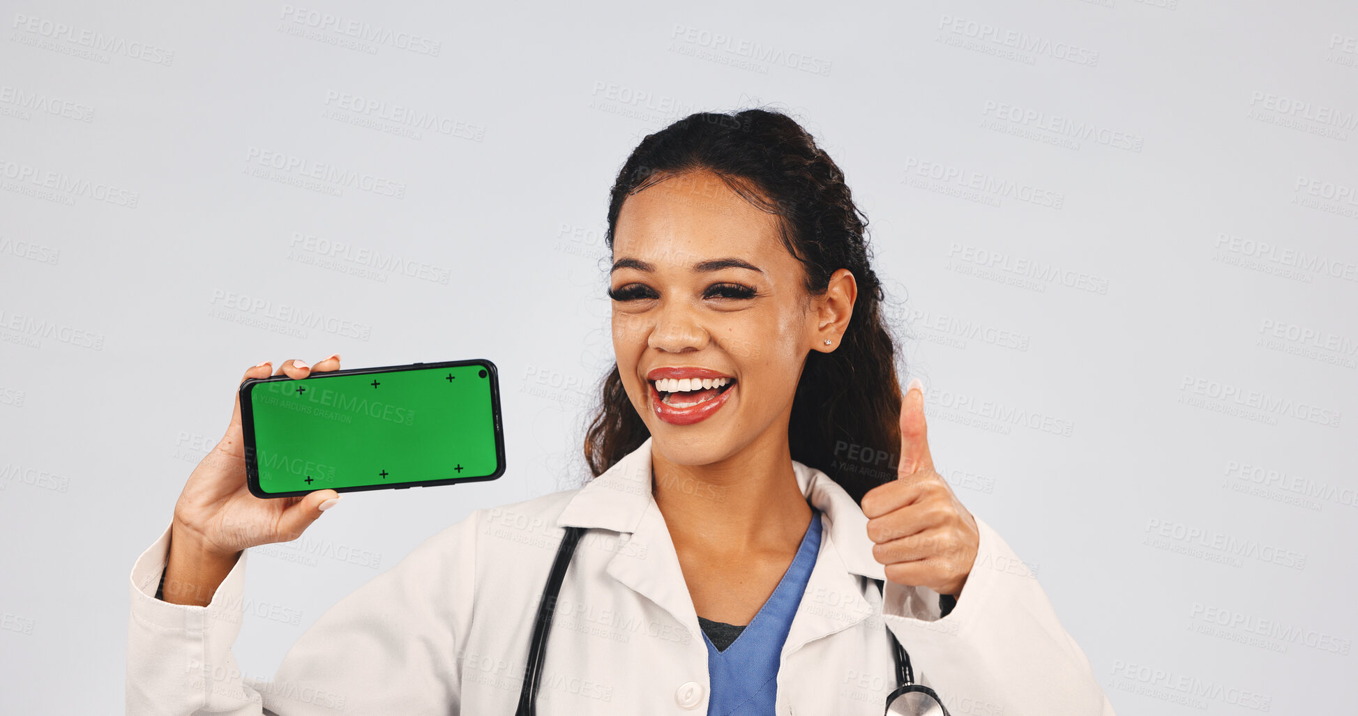 Buy stock photo Doctor, phone and green screen with woman, thumbs up and mockup approval for results or telehealth ux. Person, studio portrait and smile by tech for yes, ui review or feedback on white background 