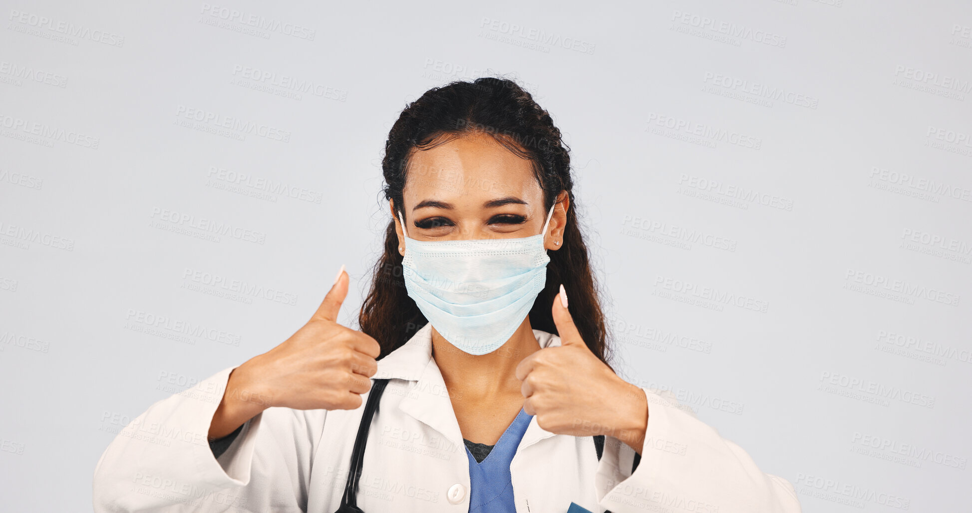 Buy stock photo Doctor, thumbs up and woman in studio with face mask, approval and agreement for healthcare. Space, portrait and medical worker with protection, safety gear and success emoji on white background