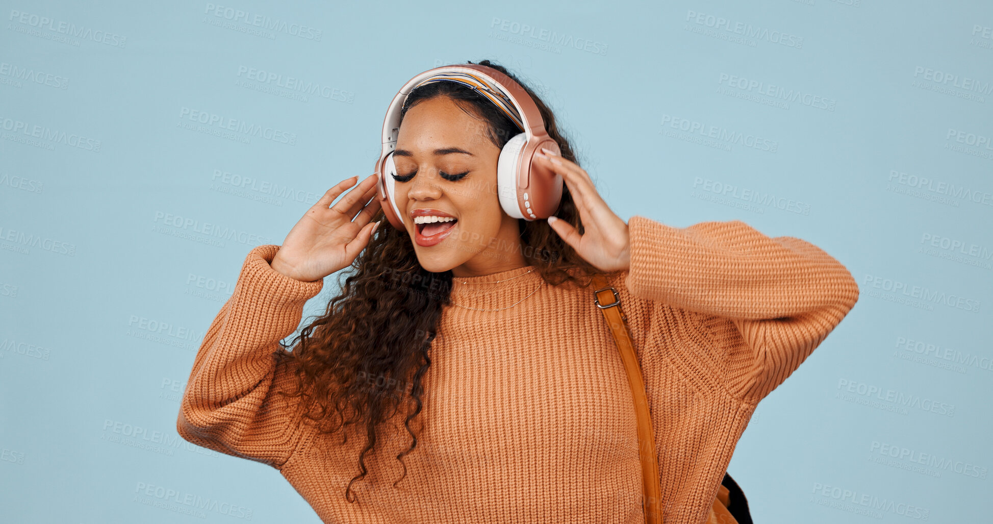 Buy stock photo Streaming, music and woman with headphones in studio, online and listening to song with subscription. Blue background, sound and happy person with tech for audio, entertainment or internet connection