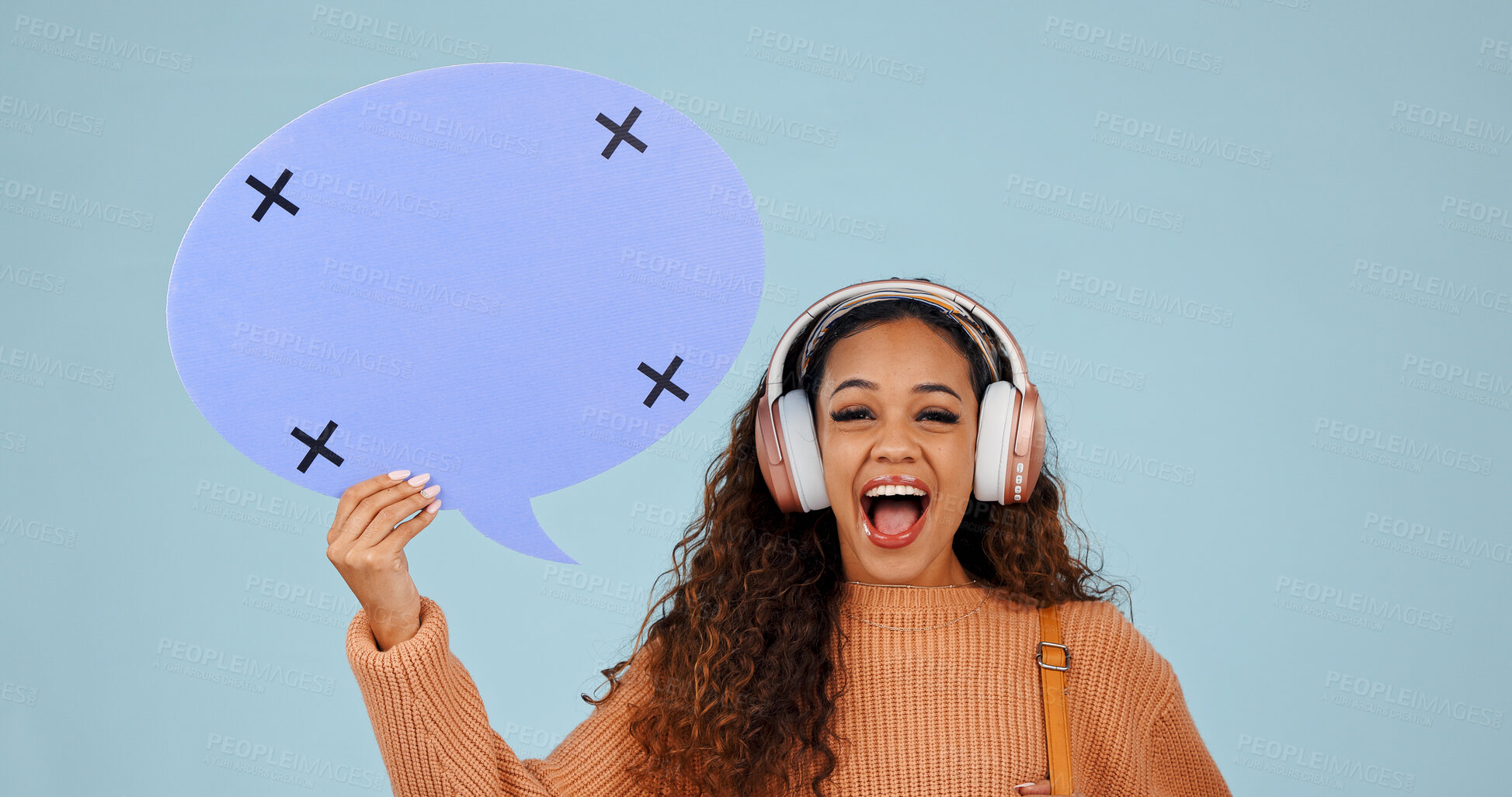 Buy stock photo Headphones, excited woman and portrait with speech bubble for voice, social media or mockup space. Smile, person or dialogue balloon for quote, opinion or streaming music on blue background in studio