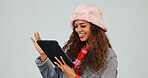 Reading, online and woman with tablet in studio, smile and laughing at funny videos on social media. Scroll, website and happy person with tech, white background and streaming comedy series on app