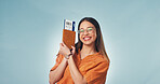 Pride, smile or woman in studio with passport, entry record or boarding pass in travel goals. Flight ticket, space or person with confidence, granted permit or tourist milestone on blue background.