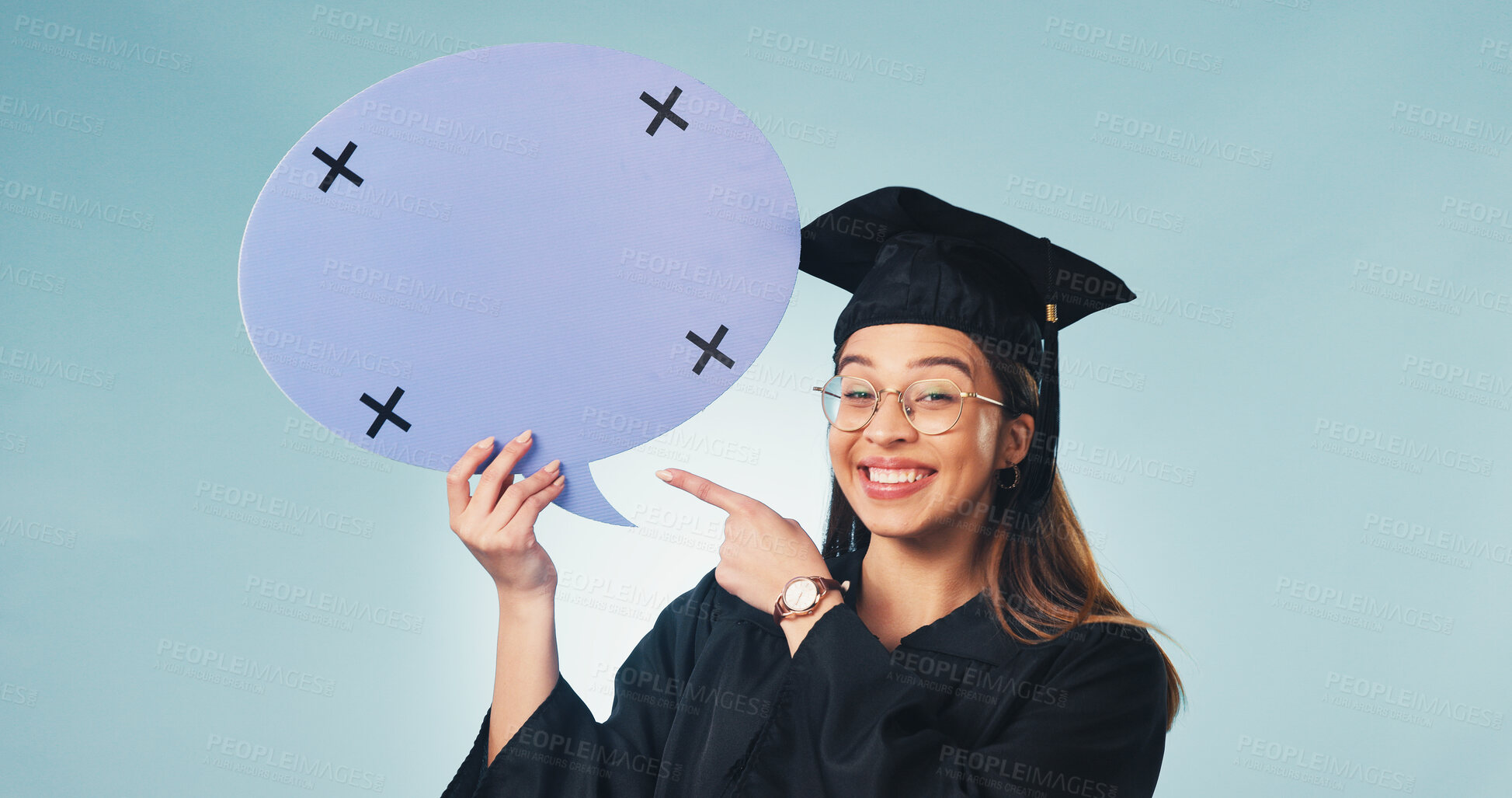 Buy stock photo Speech bubble, portrait and happy woman in studio for graduation, success and college opinion. Pointing, mockup and graduate with poster for university, feedback and social media on blue background