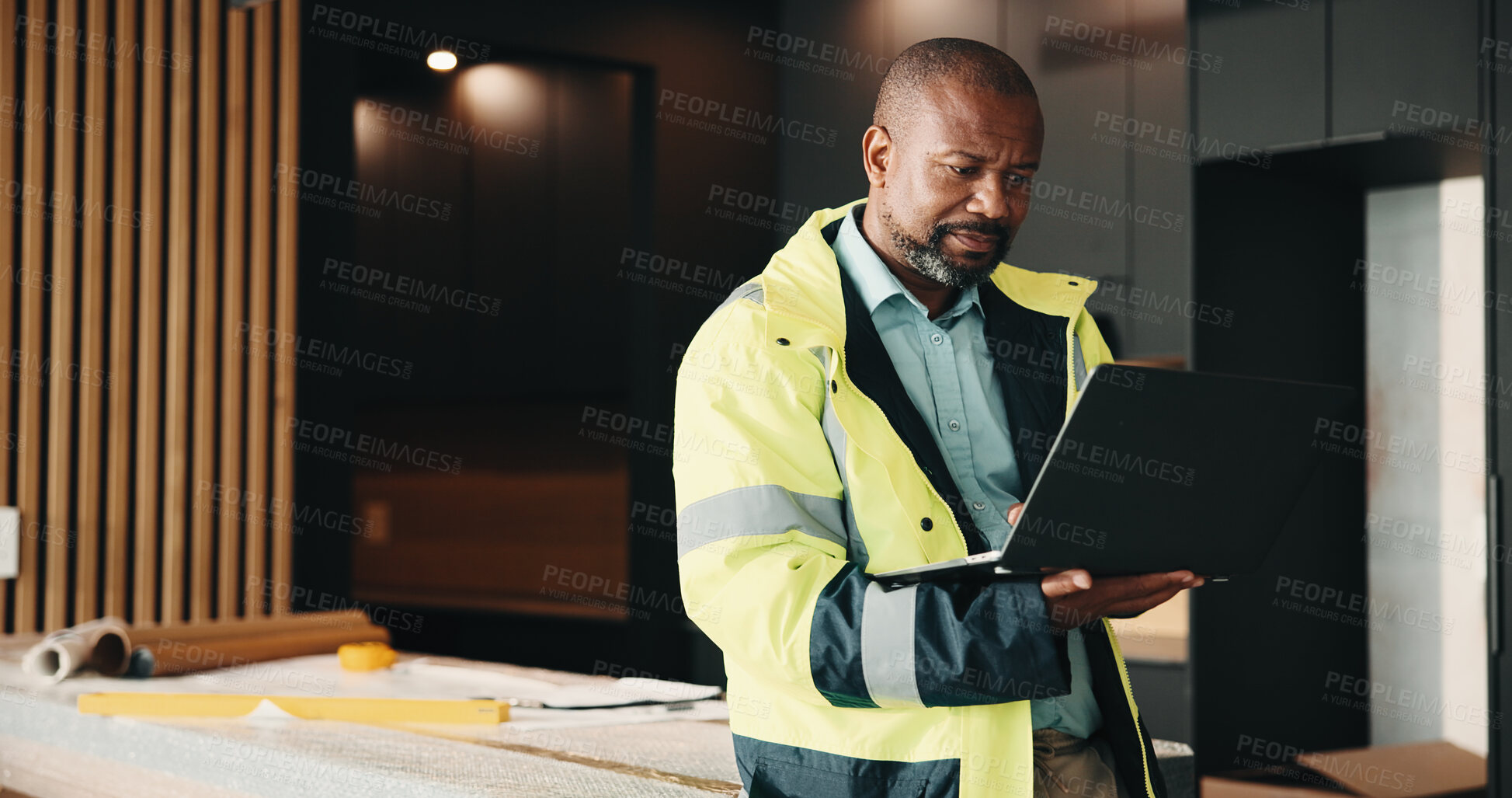 Buy stock photo Architect, man and research home renovation with laptop for planning, design or property development. Mature, black person and computer in house for architecture, review layout or remodeling project.