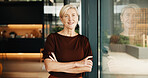 Portrait, window or happy woman with confidence in home for small business startup or career development. Mature, female person or smile with arms crossed or reflection for creative ambition in house