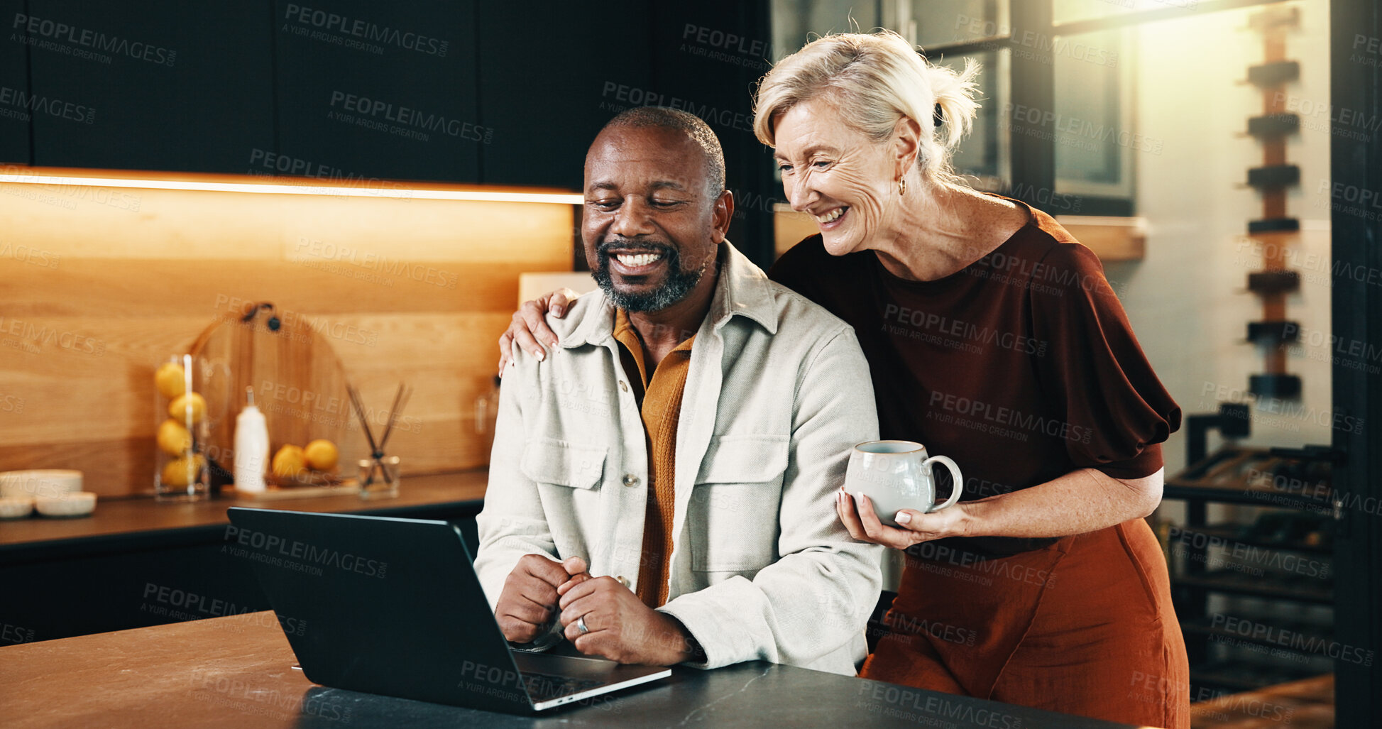 Buy stock photo Mature, couple and smile in home with laptop, planning holiday and booking reservation for travel. Happy, interracial marriage and people in house with computer, coffee and research for vacation