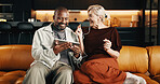 Interracial couple, tablet and smile with earphones for movie, mobile app and conversation in home. Mature people, chat and laugh for streaming, subscription and tech for humor on social media