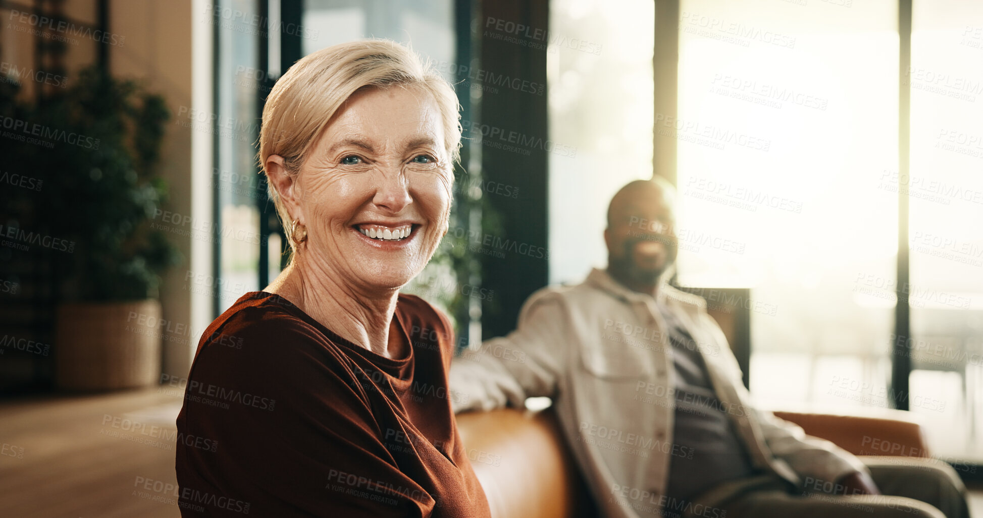 Buy stock photo Happy, relax and portrait with couple on sofa in home for bonding, weekend or holiday together. Interracial relationship, man and mature woman with smile on living room couch for break in house