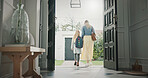 Mother, leaving and girl in home with backpack, support and back to school for education. Woman, walking or front door with daughter for commute, morning routine and bonding together for learning