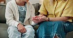 Parent, holding hands and comfort for child in lounge, connection and bonding with daughter on break. Family, love and kindness with gesture, support and person with kid, empathy and trust in home