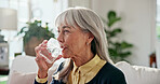 Senior, woman and drinking with water in home for medical symptoms, recovery or hydration. Elderly, female person or mineral liquid with glass for pharmaceutical medicine, treatment or medication