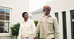 Holding hands, happy and couple by new home for moving, property investment or real estate. Walking, mature people and black man with woman for bonding in backyard at house for connection together.