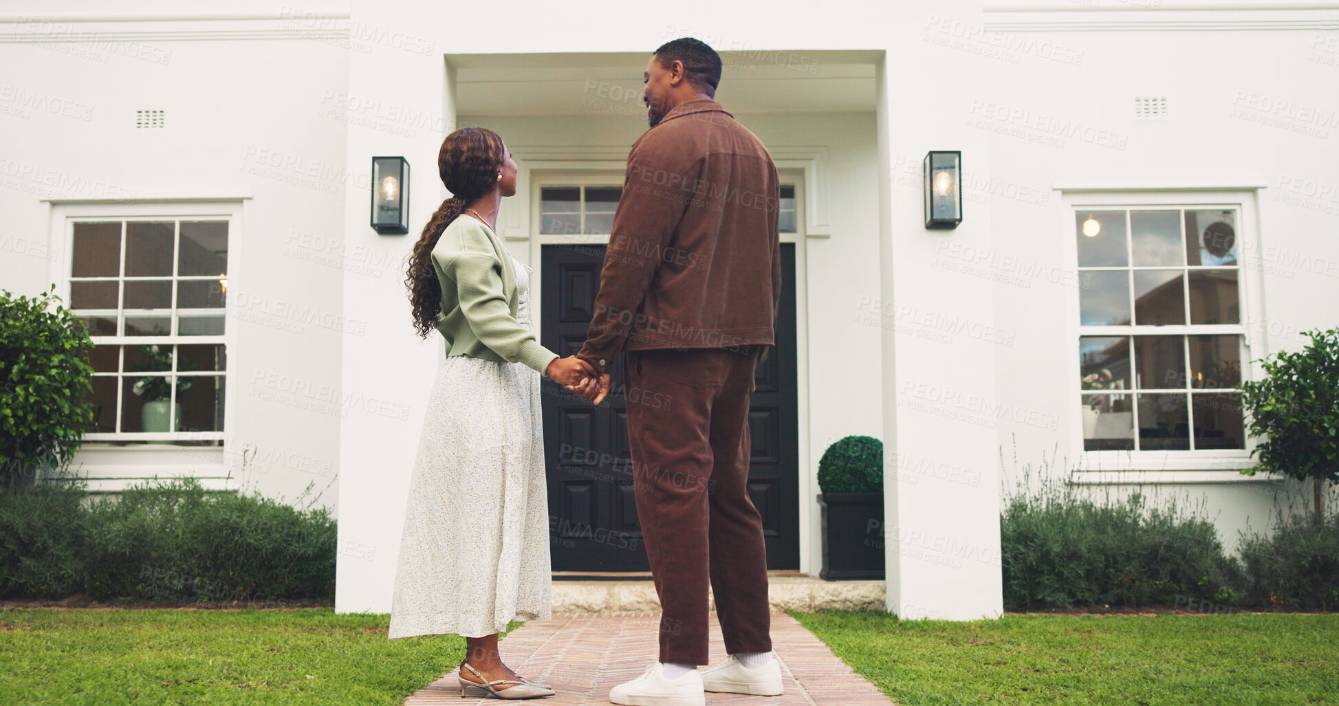 Buy stock photo Holding hands, new home and pride with black couple outdoor for property investment and purchase. Mortgage, real estate and security with man, woman and support for  relocation to dream house
