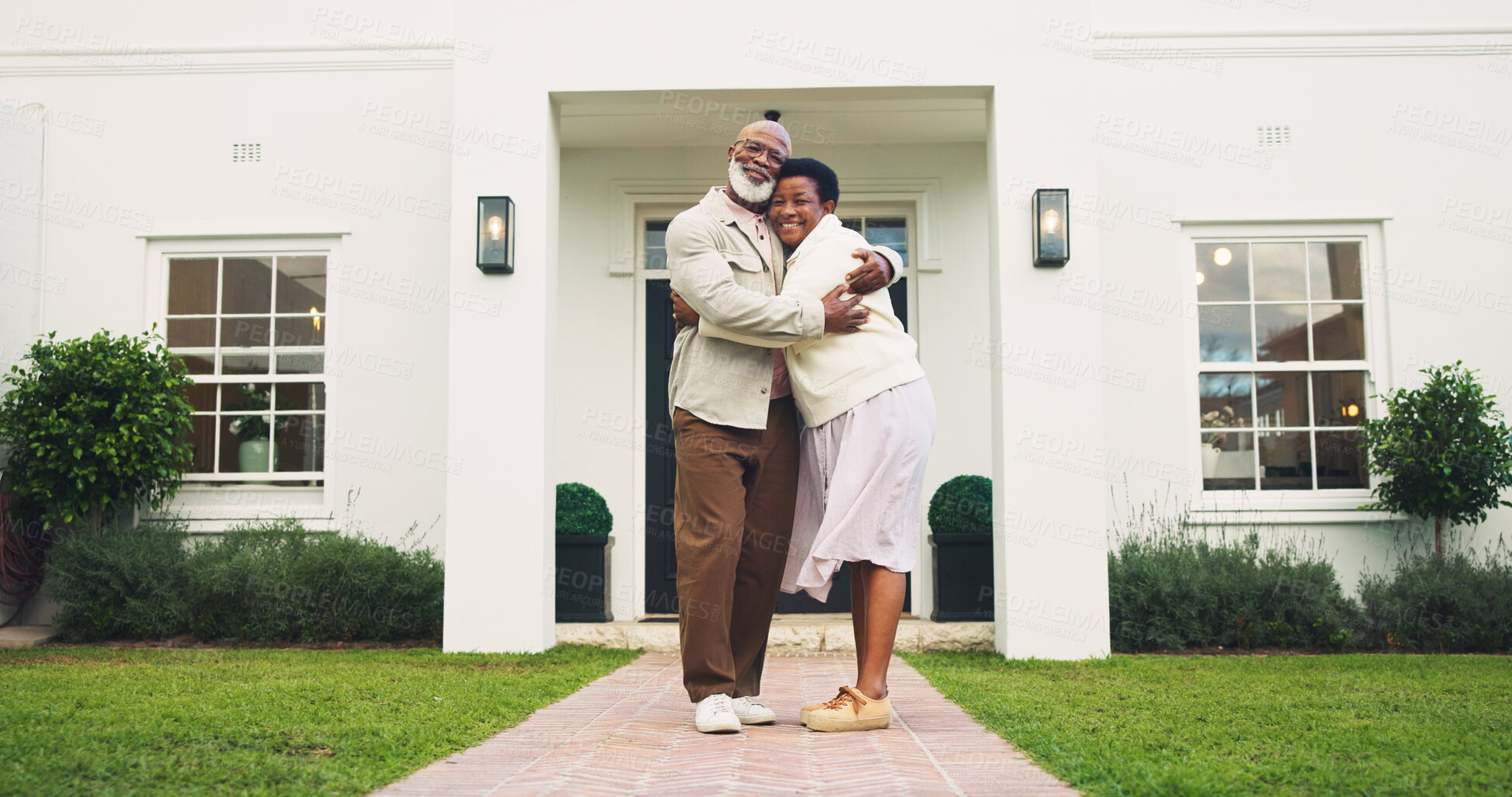 Buy stock photo Portrait, couple and hug in front yard with new house, property investment and real estate goals. Mature, black people and moving in home with relocation, mortgage loan or embrace for love with smile
