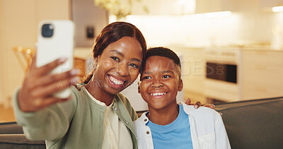 Buy stock photo Selfie, smile and son with mom on sofa in home living room for bonding, memories or social media. Black family, love and security with woman hugging boy child for photograph or profile picture