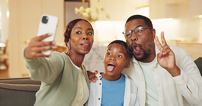 Buy stock photo Funny face, selfie and son with parents on sofa in home for bonding, memories or social media. Black family, love or tongue out with boy child, dad and mom for photo, profile picture or peace sign