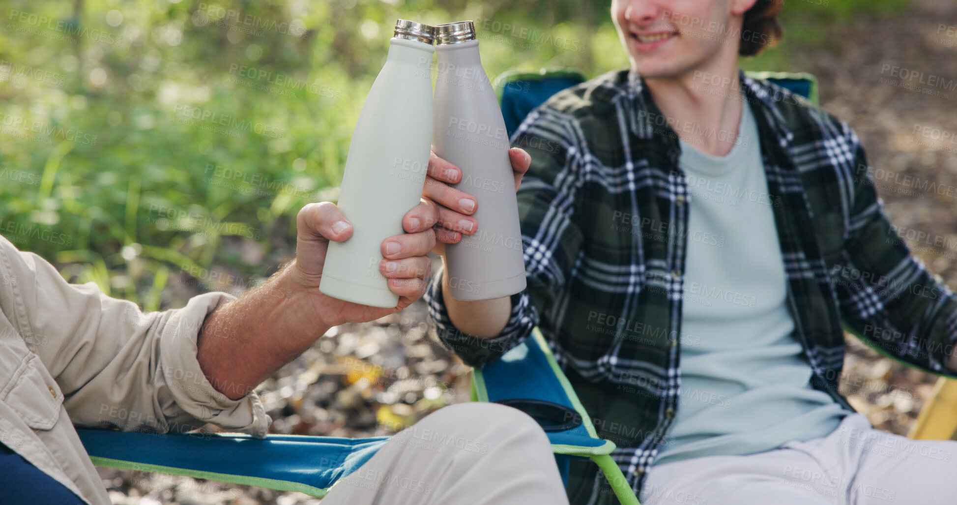 Buy stock photo People, hands and camping with cheers in nature for travel or outdoor bonding together in forest. Men, friends or drink with toast, smile or chair for vacation, holiday or weekend trip in wilderness