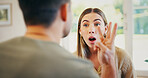 Shock, argument and couple in home with conflict, breakup or cheating confession in relationship. Angry, fighting and female person with husband for divorce, infidelity or affair in living room.