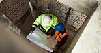 Above, blueprint and engineer team on construction site for planning, renovation design or meeting. People, floorplan and contractors at worksite for urban development with infrastructure maintenance