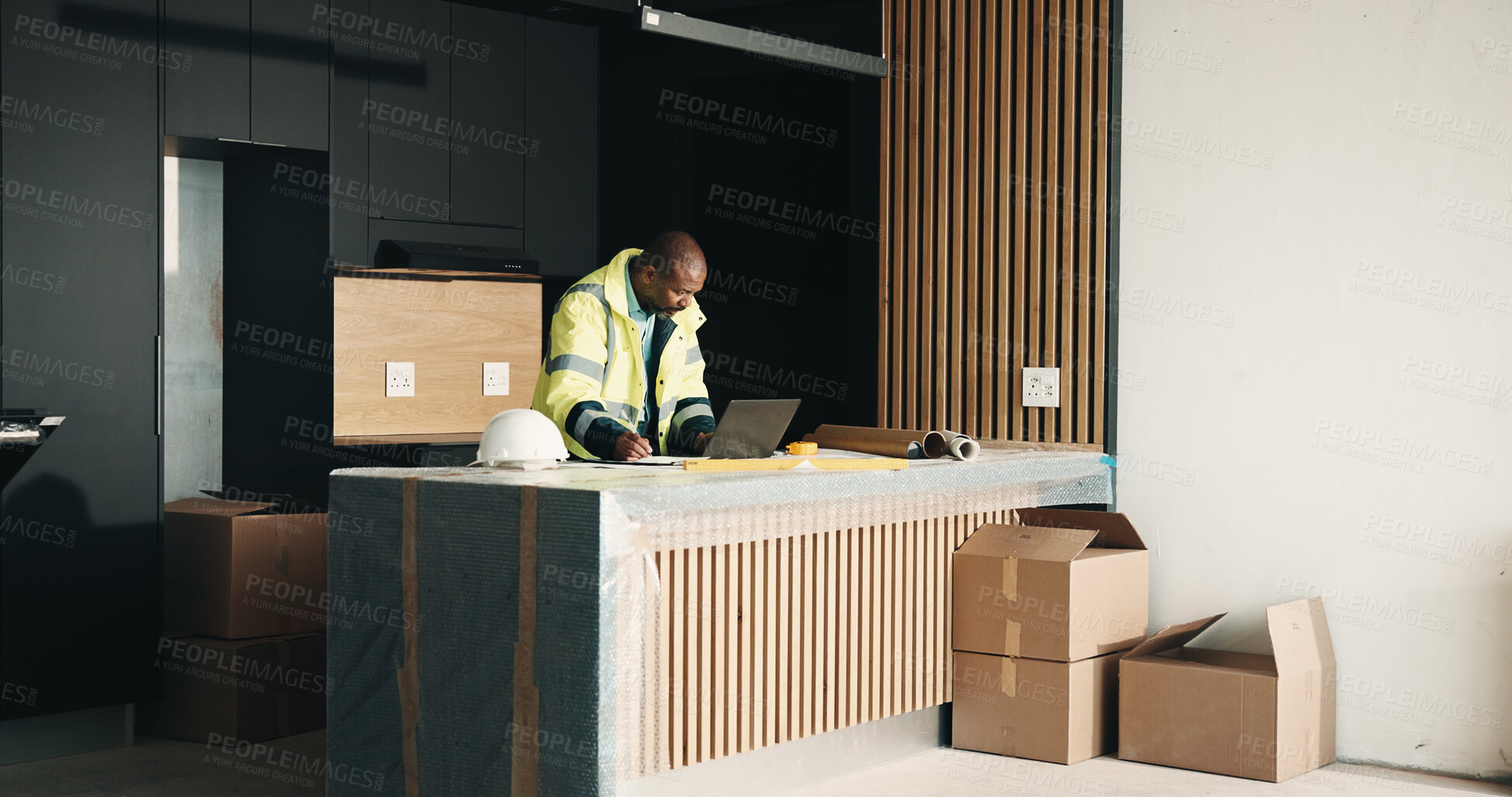 Buy stock photo Architect, man and writing in new home with laptop, renovation cost and invoice for property upgrade. Mature, black person and computer in house for architecture, notes and remodeling project quote.