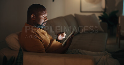 Buy stock photo Tablet, relax and black man in home at night for reading blog on budget, savings and investment planning. Digital technology, scroll and mature person on a app for financial tips, advice or guidance