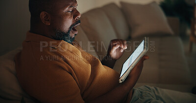 Buy stock photo Tablet, yawn and black man in home at night for reading blog on budget, savings and investment planning. Digital technology, tired and mature person on app for financial tips, advice or guidance.