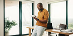 Creative, black man and reading in home office with tablet, research and sketch for animation. Smile, mature person or freelancer at house with digital, editing cartoon and graphic design for project