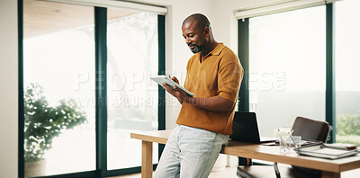 Buy stock photo Creative, black man and reading in home office with tablet, research and sketch for animation. Smile, mature person or freelancer at house with digital, editing cartoon and graphic design for project