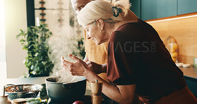 Buy stock photo Cooking, smell and stove with interracial couple in kitchen of home together for meal preparation. Aroma, bonding and steam with mature people in apartment for culinary hobby or food wellness