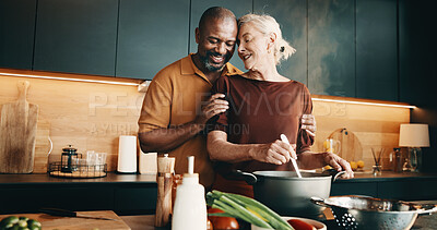 Buy stock photo Cooking, hug and smile with interracial couple in kitchen of home together for meal preparation. Bonding, love and security with mature people in apartment for culinary hobby, food or wellness