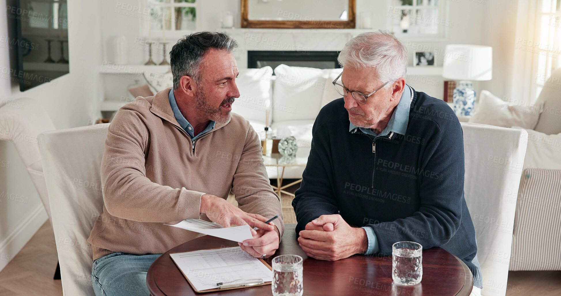 Buy stock photo Man, advisor and talking at house with document, finance report or form for loan application. Mature people, consultant and reading in lounge with paperwork, financial clipboard and retirement policy