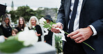 Gravestone, hand and rose in graveyard with funeral, people mourning and grief for burial ceremony. Tombstone, flower and man in cemetery outdoor with memorial service, family death and bereavement.