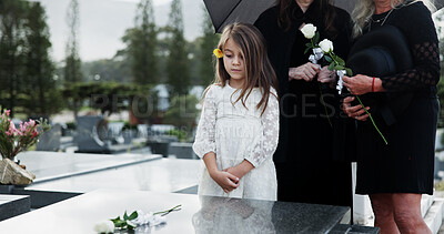 Buy stock photo Sad, child and rose in graveyard with tombstone, funeral and people mourning for burial ceremony. Family, girl and flower in cemetery outdoor with grief, sorrow and gravestone for memorial service.