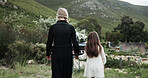 Holding hands, mother and girl in graveyard, back and emotions for grief, compassion and loss. Family, parent and daughter with support for funeral, people or cemetery for burial, comfort or empathy