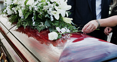 Buy stock photo Woman, hand and rose in cemetery with coffin, funeral service and people mourning for burial ceremony. Person, white flower and casket in graveyard outdoor with memorial, family death or bereavement.