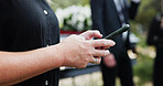 Funeral, hands and woman in cemetery, cellphone for online chatting and post for memory. Family, connection and person in graveyard, smartphone and message to contact and picture to remember and sad