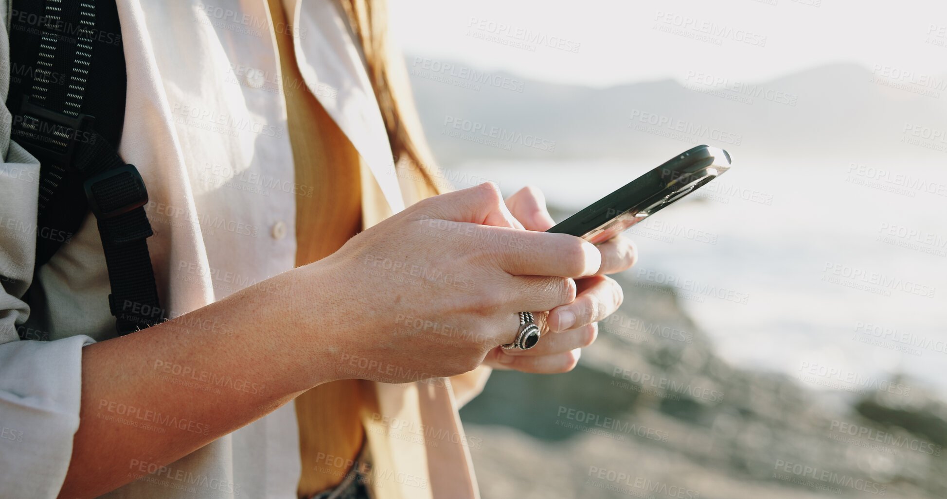 Buy stock photo Hands, texting and phone with woman at beach for travel blogger, social media and summer vacation post. Communication, online holiday guide and contact with person outdoor for tourism and chat
