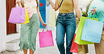 Women, hands and friends with shopping bags for discount,  fashion or clothing style together. Legs, female people or shoppers walking with gifts or presents for payment, purchase or outing in city