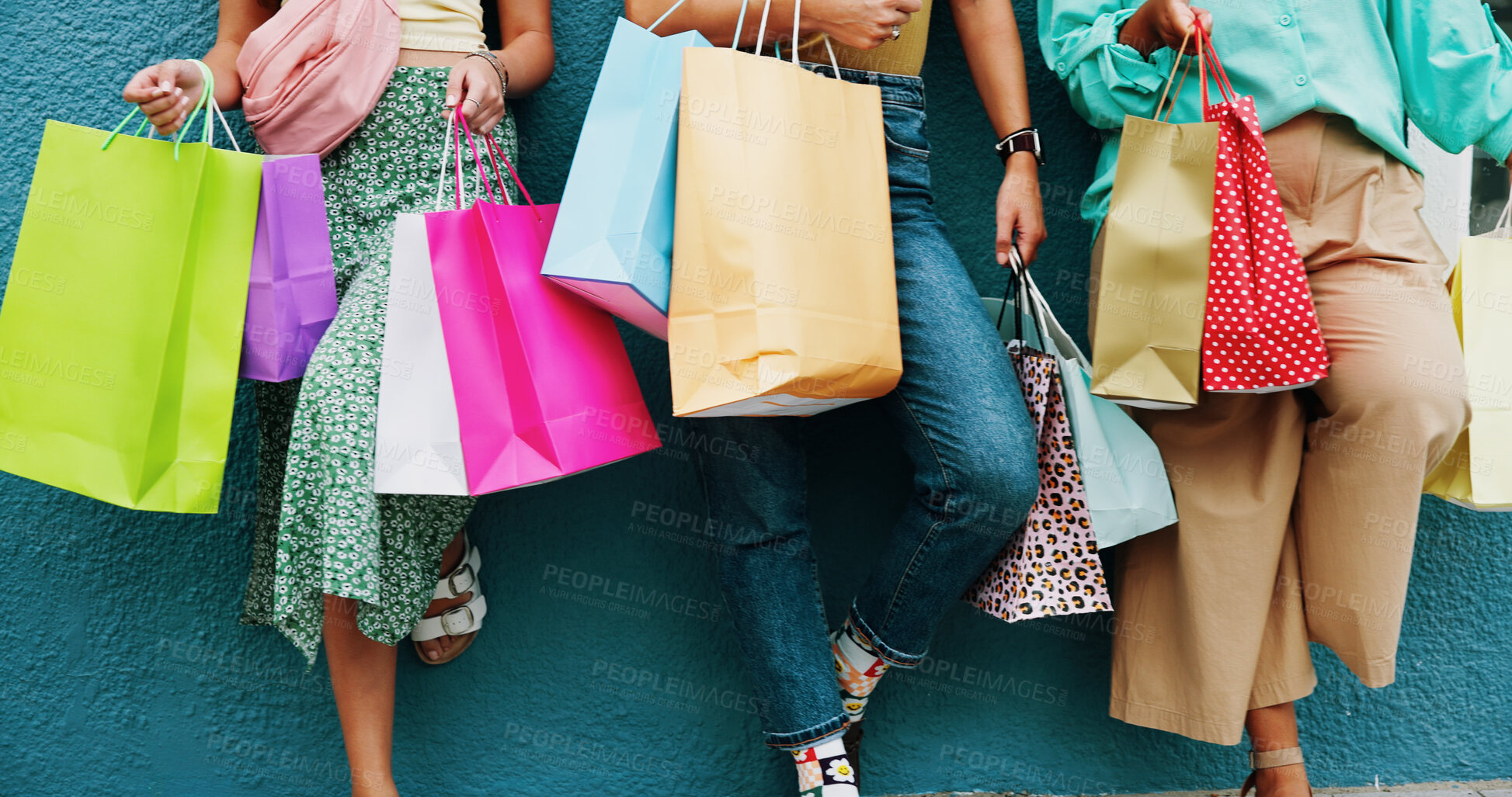 Buy stock photo Women, legs and wall with shopping bags for discount, fashion sale or promotion deal together. Female people, friends or shoppers with gifts or presents for clothing, style or retail commercial