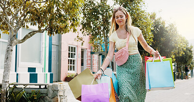 Buy stock photo Shopping bag, sale and heavy with woman in city for black Friday deal, overconsumption and shopaholic. Consumerism, promotion and boutique product with person outdoor for customer and retail crisis
